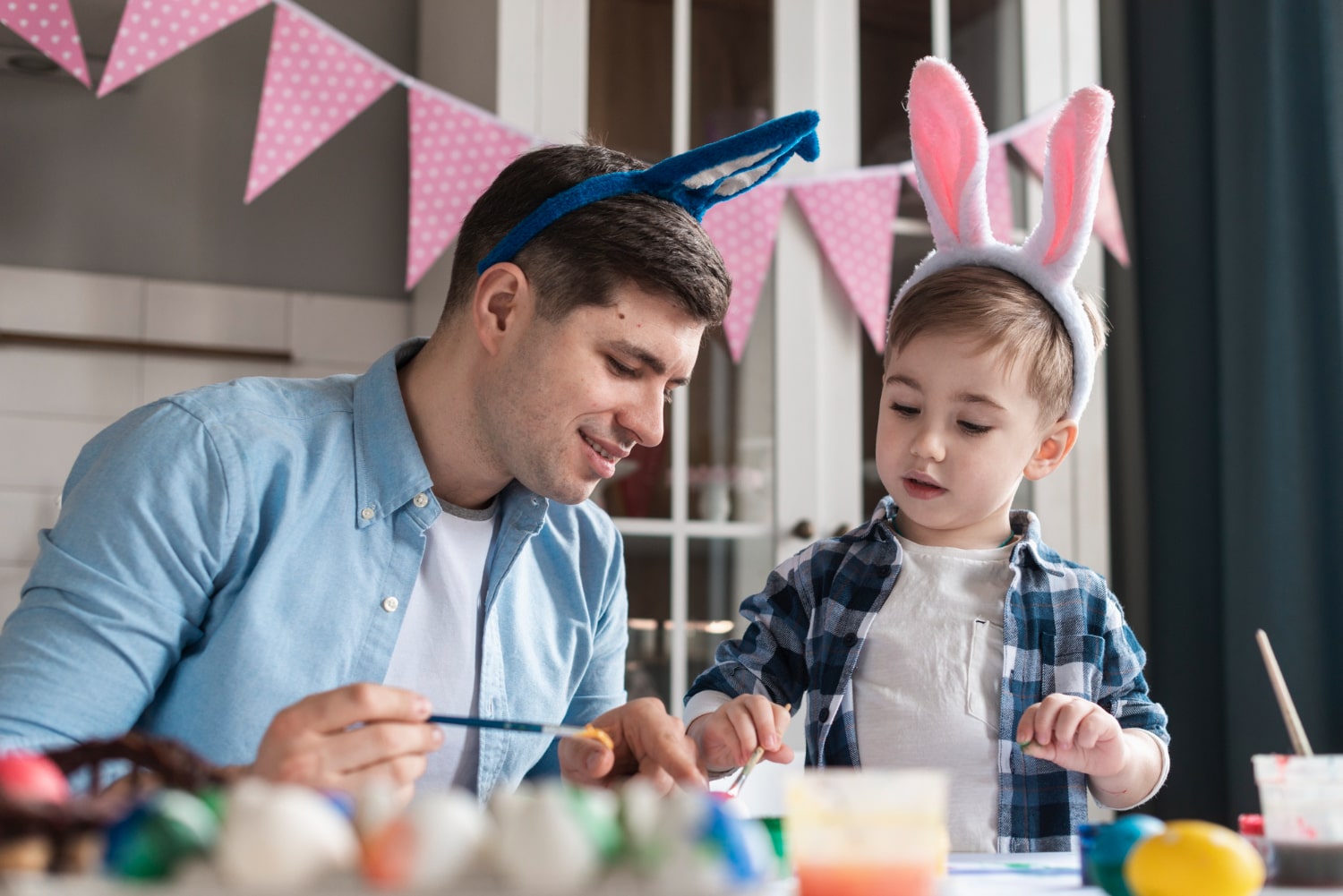son and father doing easter craft